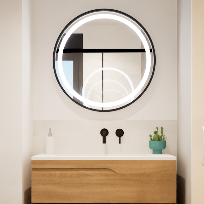 Piso Vilanova i la Geltrú Cuarto de baño moderno con lavabo, espejo circular iluminado y planta en una repisa.